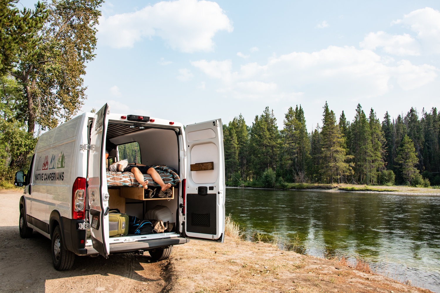 Lounging in a Campervan rental by a lake