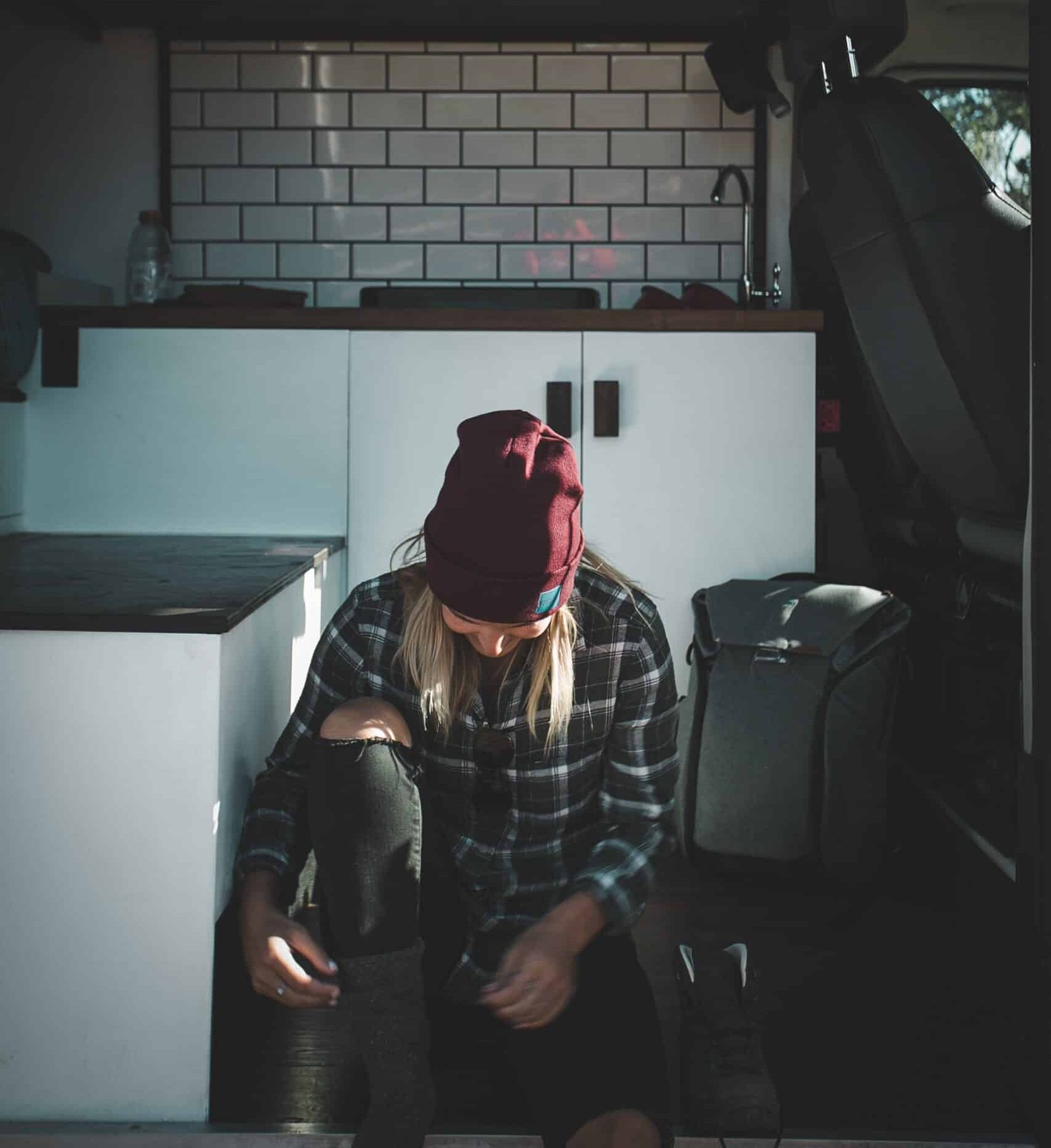 Getting read for a hike while sitting in a campervan