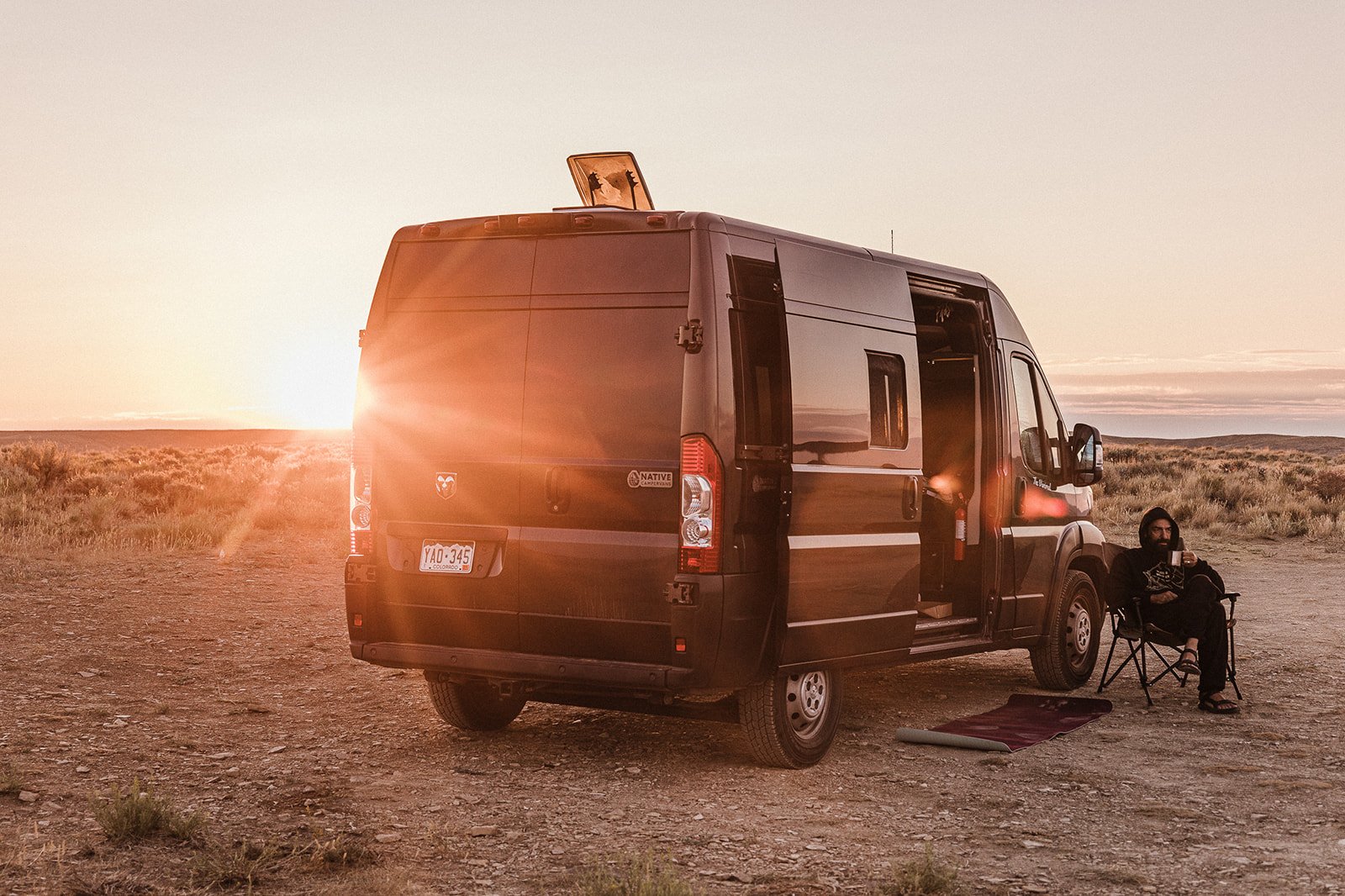 man sitting by campervan rental Colorado