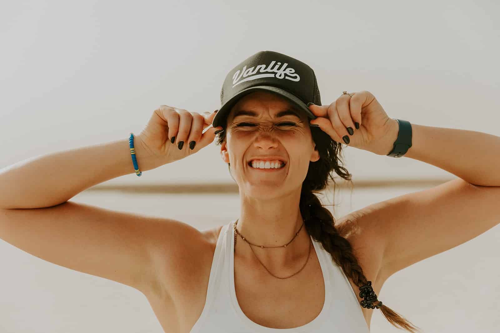 Woman smiling with a Vanlifer hat on