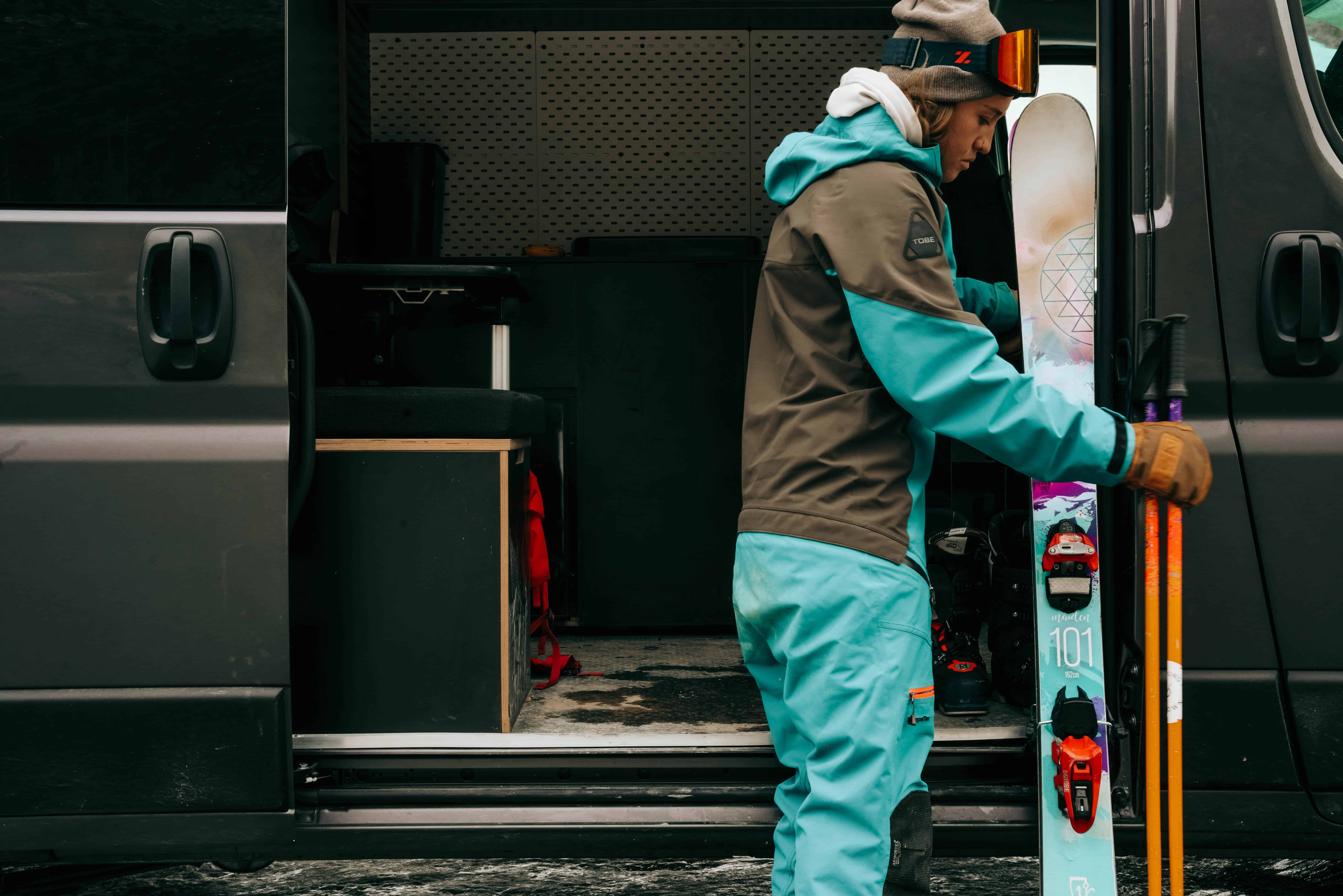 Gearing up to ski in front of a Campervan