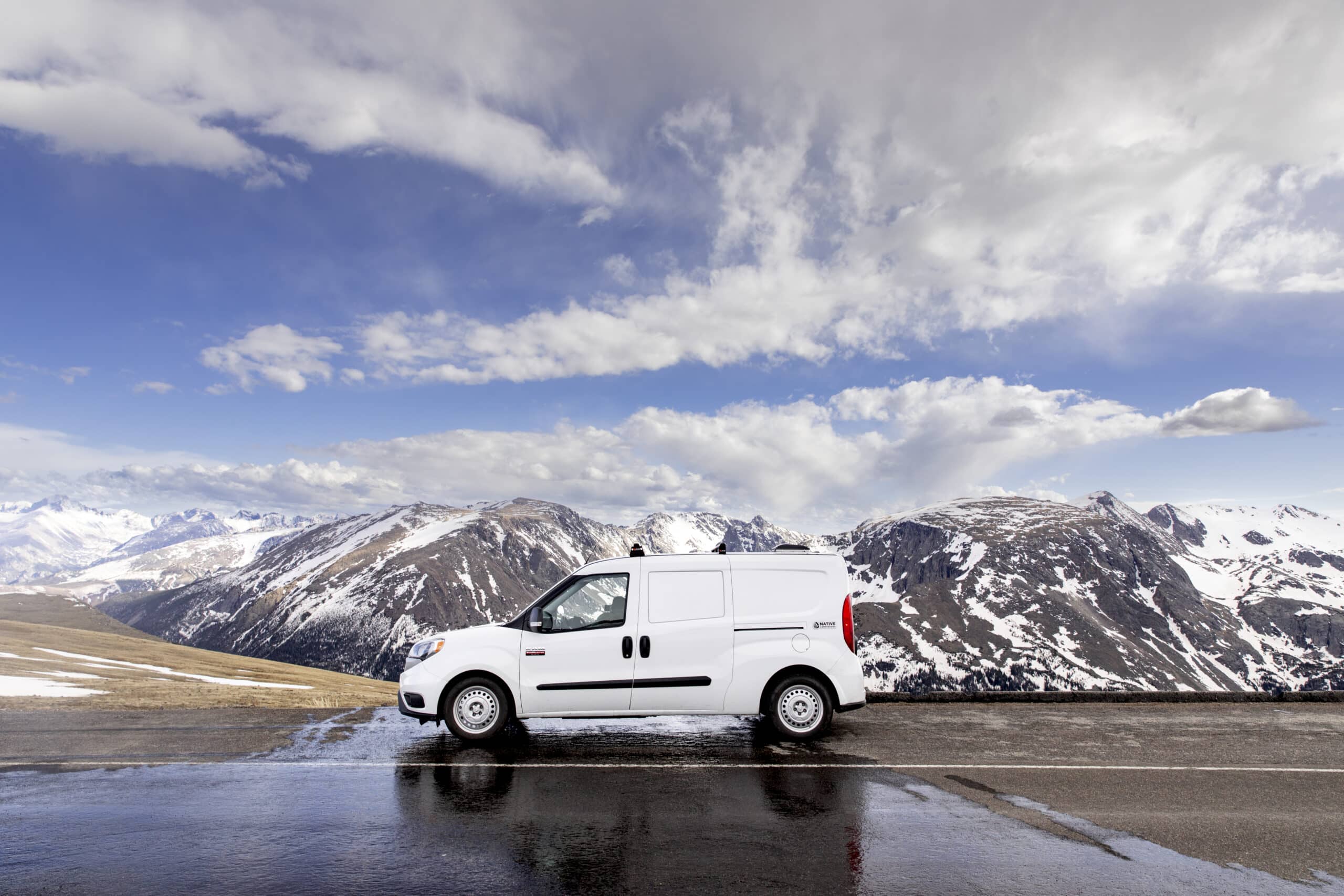 Small Campervan with a view of mountains behind